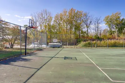 an empty tennis court with a basketball hoop at Pet-Friendly Oak Harbor Condo Walk to Lake! in Sand Beach