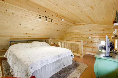 a bedroom with a bed in a log cabin at Idyllic Cabin in the Heart of Hocking Hills in Rockbridge