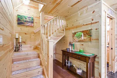 a cabin with a staircase and a sink in a room at Idyllic Cabin in the Heart of Hocking Hills in Rockbridge