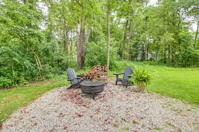 a fire pit with chairs and a grill in a yard at Idyllic Cabin in the Heart of Hocking Hills in Rockbridge