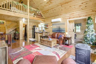 a living room with a couch and a table at Idyllic Cabin in the Heart of Hocking Hills in Rockbridge