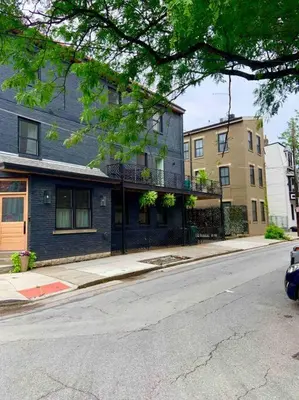 an empty city street with buildings and a tree at This property is unlisted in Cincinnati