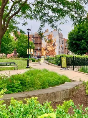 a park with a statue of a woman on a building at This property is unlisted in Cincinnati