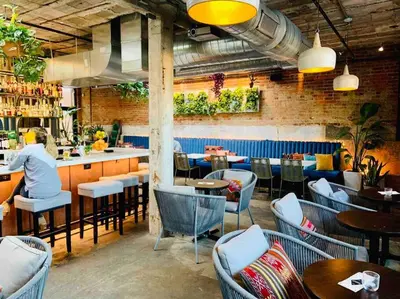a restaurant with tables and chairs and a bar at Modern/ parking/Eden Park/near Downtown/ FCC in Cincinnati