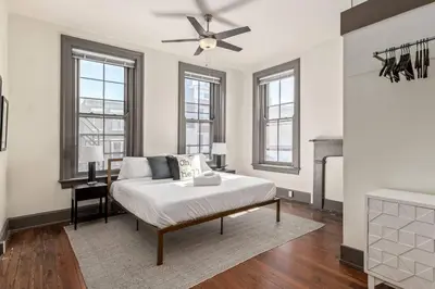 a living room with a bed and a fireplace at Deluxe 5-bedroom Walk everywhere in Over the Rhine in Cincinnati