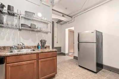 a kitchen with a sink and a refrigerator at Deluxe 5-bedroom Walk everywhere in Over the Rhine in Cincinnati