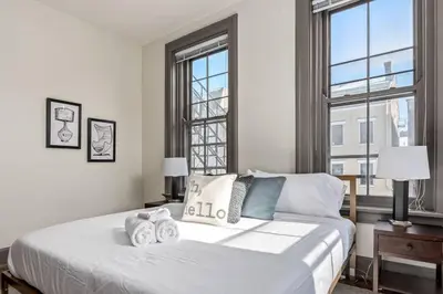 a bedroom with a large white bed with two pillows at Deluxe 5-bedroom Walk everywhere in Over the Rhine in Cincinnati