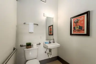 a bathroom with a white toilet and a sink at Deluxe 5-bedroom Walk everywhere in Over the Rhine in Cincinnati