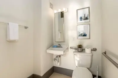 a bathroom with a white toilet and a sink at Deluxe 5-bedroom Walk everywhere in Over the Rhine in Cincinnati