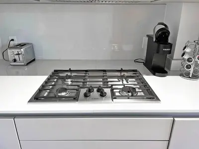 a stove top oven sitting on top of a kitchen counter at Luxury 4-Bedroom Retreat in the Heart of Over the Rhine in Cincinnati