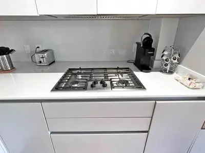 a kitchen counter with a stove top in a kitchen at Luxury 4-Bedroom Retreat in the Heart of Over the Rhine in Cincinnati