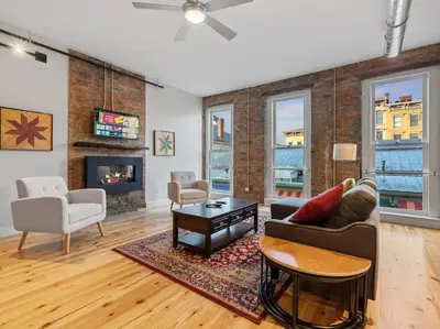 a living room with a couch and a table at Luxury 4-Bedroom Retreat in the Heart of Over the Rhine in Cincinnati