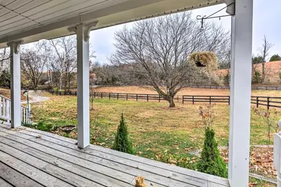 a porch with a view of a field at Lovely Sadieville Retreat with Deck and Grill! in Corinth