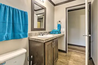 a bathroom with a sink and a mirror at Lovely Sadieville Retreat with Deck and Grill! in Corinth