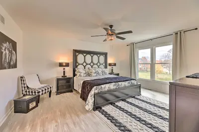 a bedroom with a bed and a ceiling fan at Luxury Maineville Villa with Private Pool and Deck in Maineville