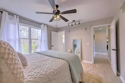 a bedroom with a bed and a ceiling fan at Luxury Maineville Villa with Private Pool and Deck in Maineville