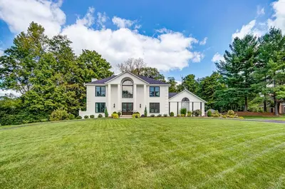 a white house with a large lawn at Luxury Maineville Villa with Private Pool and Deck in Maineville