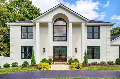 a white house with black windows at Luxury Maineville Villa with Private Pool and Deck in Maineville