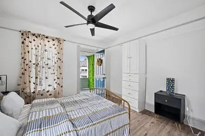 a bedroom with a bed and a ceiling fan at Center of Little Italy #4 in Cleveland