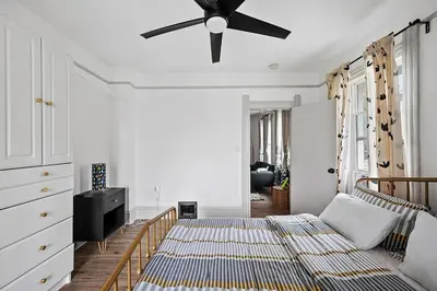 a bedroom with a bed and a ceiling fan at Center of Little Italy #4 in Cleveland