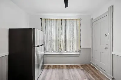 a kitchen with a refrigerator and a window at Center of Little Italy #4 in Cleveland
