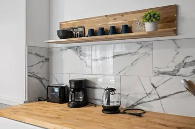 a kitchen counter with appliances on a wooden counter top at Center of Little Italy #4 in Cleveland