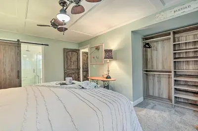 a bedroom with a large bed and a table at Riverfront Zanesville Getaway with Private Bar! in Dresden