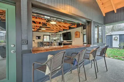 a bar with chairs in front of a counter at Riverfront Zanesville Getaway with Private Bar! in Dresden
