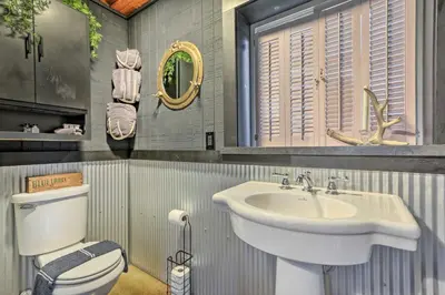 a bathroom with a sink and a toilet at Riverfront Zanesville Getaway with Private Bar! in Dresden