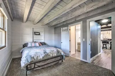 a bedroom with a bed in a room at Spacious Massillon Log Cabin with Fire Pit! in Massillon