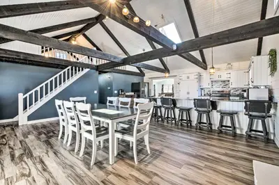 a dining room with a table and chairs at Spacious Massillon Log Cabin with Fire Pit! in Massillon