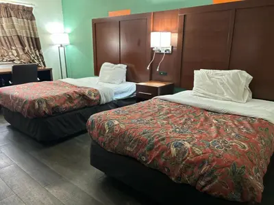 a hotel room with two beds in a room at Hillcrest Motel by Oyo Aurora near Lawrenceburg in Aurora