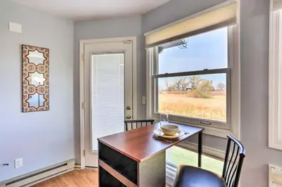 a dining room with a table and a window at Quaint Couples Escape Pool, Near Lake Erie! in Oak Harbor