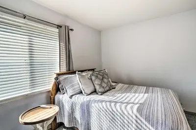 a bedroom with a bed and a window at Quaint Couples Escape Pool, Near Lake Erie! in Oak Harbor