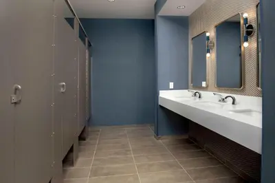 a bathroom with two sinks and two mirrors at Hilton Garden Inn Florence Cincinnati Airport South in Florence