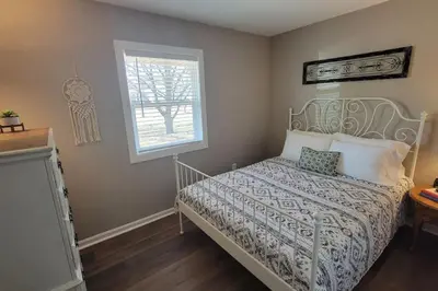 a bedroom with a white bed with a window at 6418 Sandric lane Beautiful 3 BDRM Ranch home in Liberty Township in Jericho