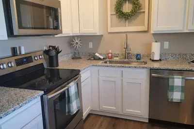 a kitchen with white cabinets and black appliances at 6418 Sandric lane Beautiful 3 BDRM Ranch home in Liberty Township in Jericho