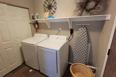 a laundry room with a washer and a tie on a shelf at 6418 Sandric lane Beautiful 3 BDRM Ranch home in Liberty Township in Jericho