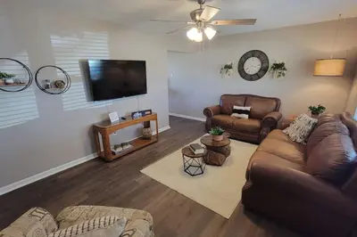 a living room with couches and a flat screen tv at 6418 Sandric lane Beautiful 3 BDRM Ranch home in Liberty Township in Jericho