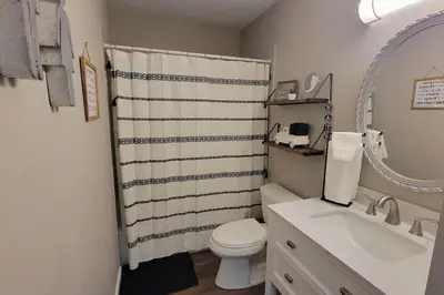 a bathroom with a toilet and a sink and a mirror at 6418 Sandric lane Beautiful 3 BDRM Ranch home in Liberty Township in Jericho