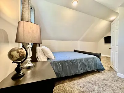 a bedroom with a bed with a lamp on a table at 7086 Tylersville Beautiful 4 BDR Home - Near I-75 in Maud