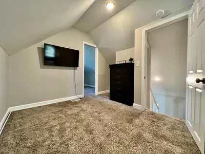 a living room with a flat screen tv and a dresser at 7086 Tylersville Beautiful 4 BDR Home - Near I-75 in Maud