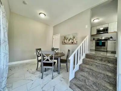 a dining room and kitchen with a table and chairs at 7086 Tylersville Beautiful 4 BDR Home - Near I-75 in Maud