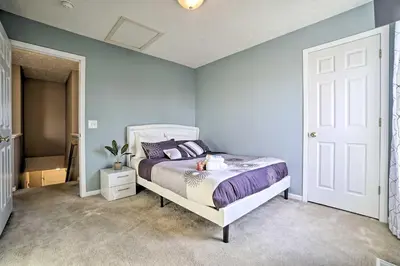 a bedroom with a bed and a blue wall at Spacious Delaware Abode with Private Backyard! in Delaware
