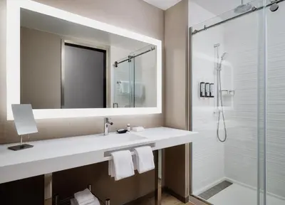 a bathroom with a sink and a shower at AC Hotel by Marriott Dayton in Dayton