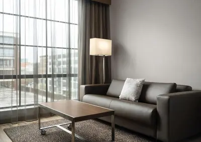 a living room with a couch and a table at AC Hotel by Marriott Dayton in Dayton