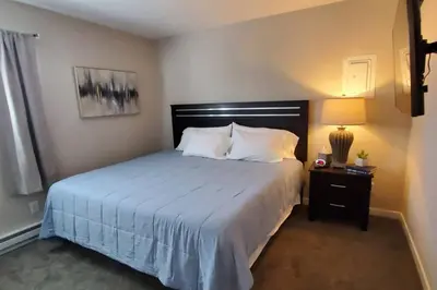 a bedroom with a bed and a night stand with a lamp at 219 Maxwell St Unit B Such a great place to work and stay in Franklin