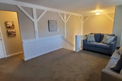 a living room with two blue couches and a staircase at 219 Maxwell St Unit B Such a great place to work and stay in Franklin