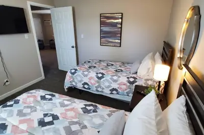 a hotel room with two beds and a tv at 219 Maxwell St Unit B Such a great place to work and stay in Franklin
