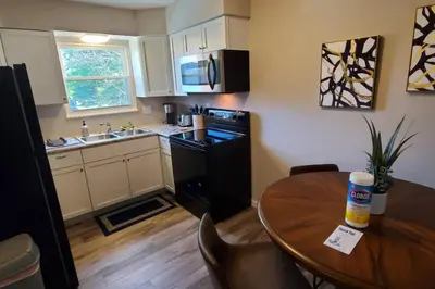 a small kitchen with a wooden table and a dining room at 219 Maxwell St Unit B Such a great place to work and stay in Franklin